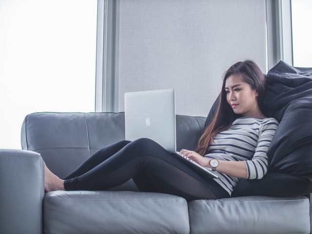 Woman on Computer on Couch